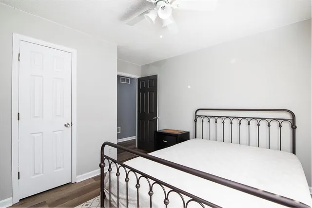 a bedroom with a bed and a chandelier