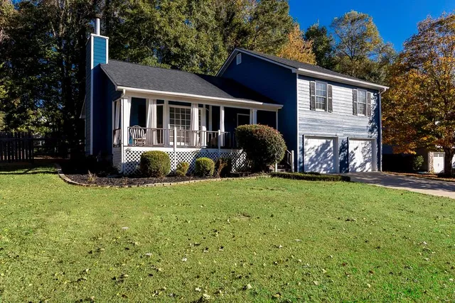 a front view of house with yard and green space