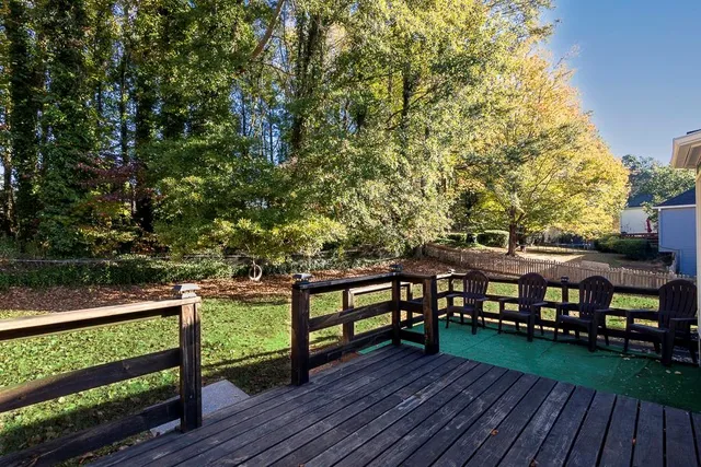 a view of a deck with furniture and trees