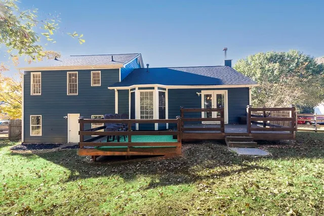 a view of a house with backyard sitting area and garden