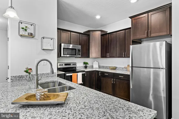 a kitchen with kitchen island a sink appliances and cabinets