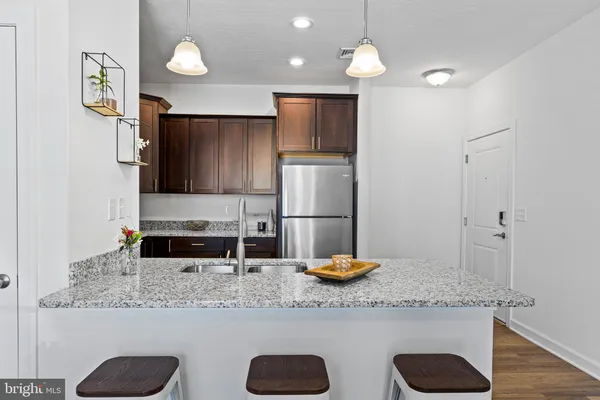 a kitchen with granite countertop cabinets and stainless steel appliances