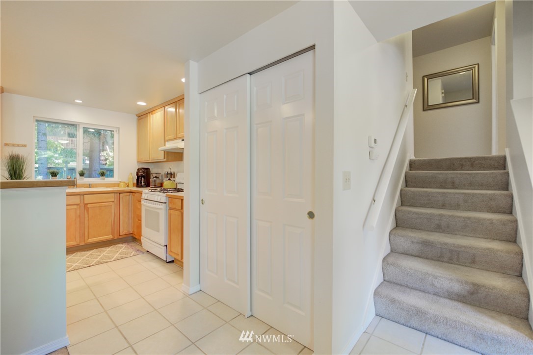 21930 3rd Place West Bothell, WA 98021 - Photo 13 of 34 a kitchen with white cabinets and white appliances