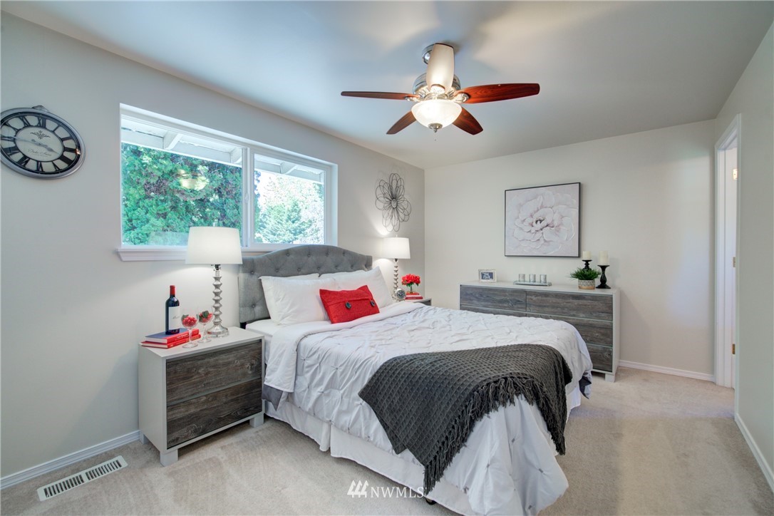 21930 3rd Place West Bothell, WA 98021 - Photo 14 of 34 a bedroom with a bed and a chandelier