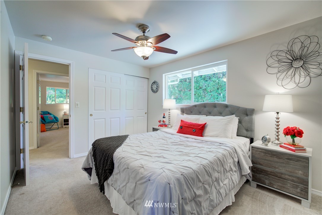 21930 3rd Place West Bothell, WA 98021 - Photo 15 of 34 a bedroom with a bed and a chandelier