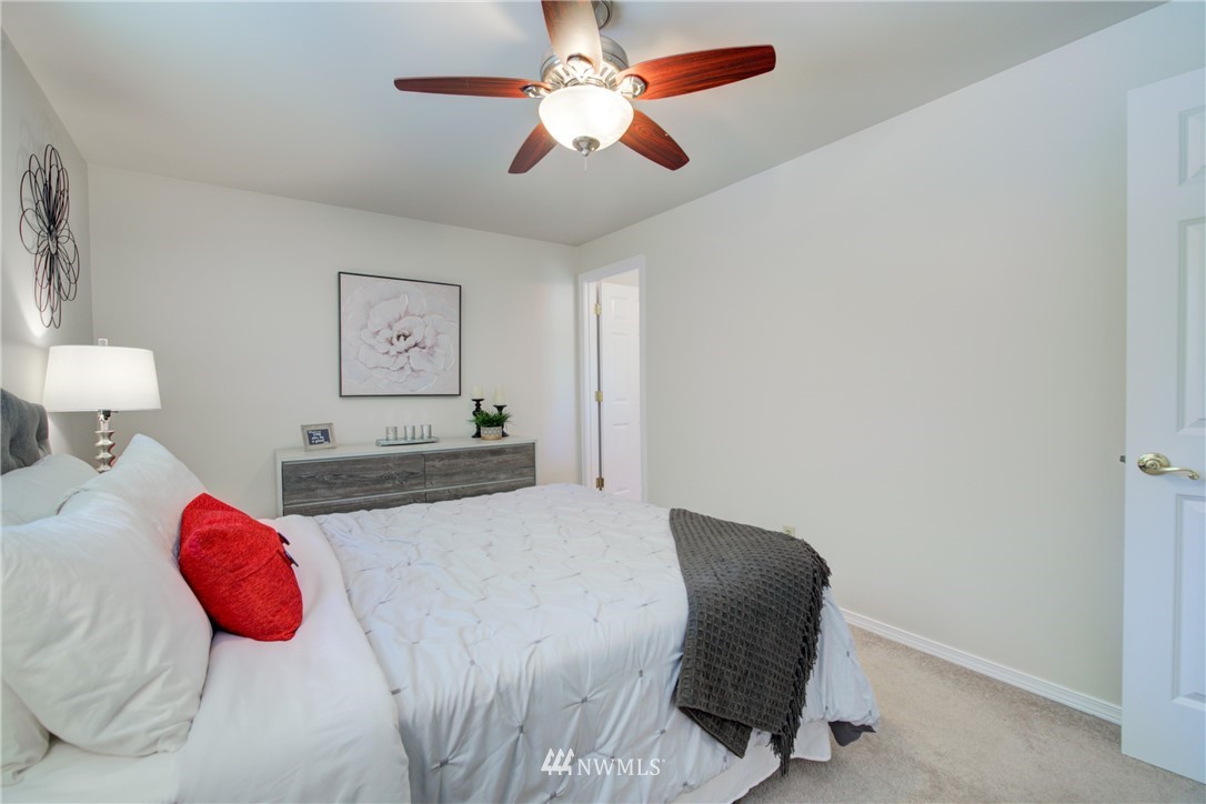 21930 3rd Place West Bothell, WA 98021 - Photo 16 of 34 a bedroom with a bed and a lamp