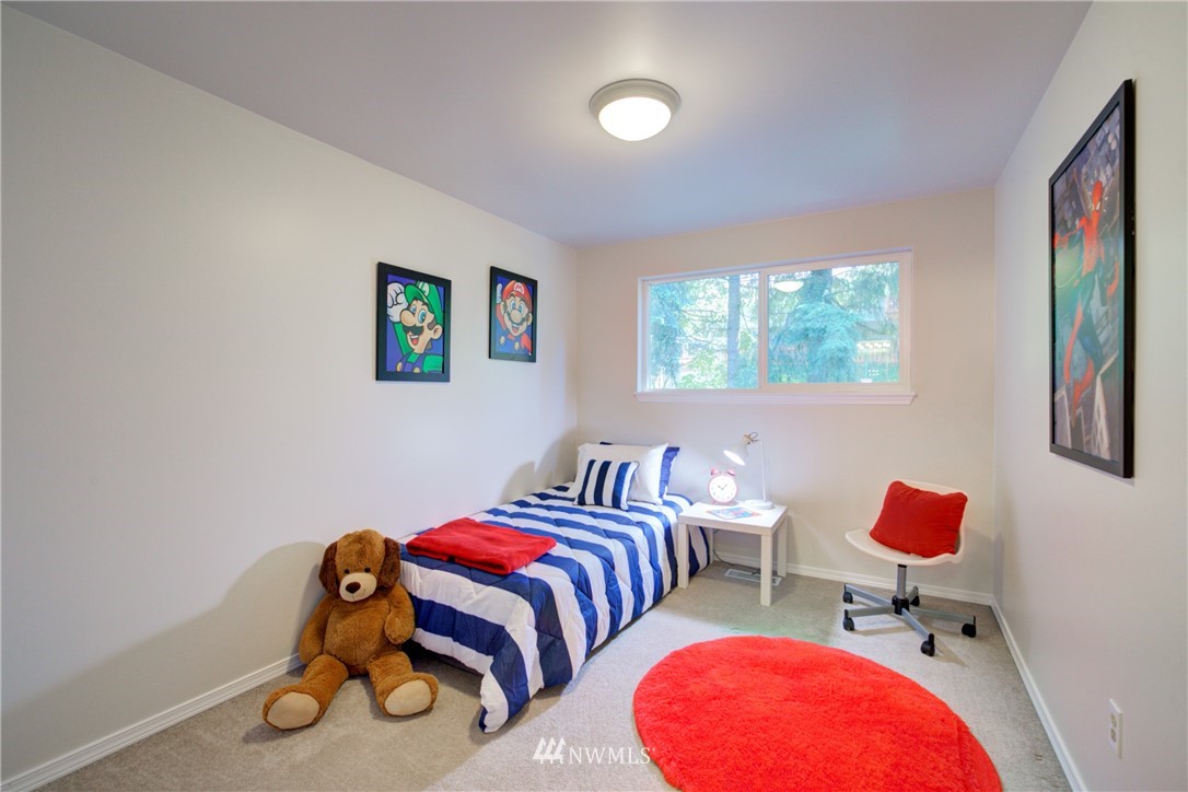 21930 3rd Place West Bothell, WA 98021 - Photo 18 of 34 a bedroom with two beds and a chair