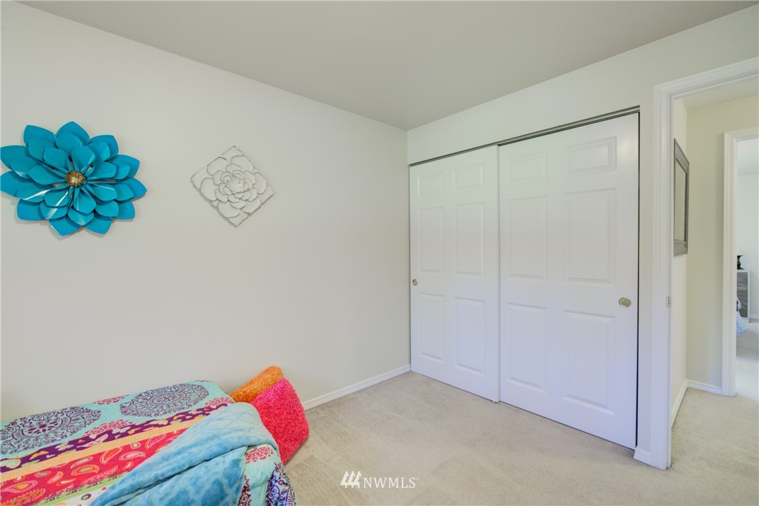 21930 3rd Place West Bothell, WA 98021 - Photo 20 of 34 a bedroom with a bed and a painting on the wall