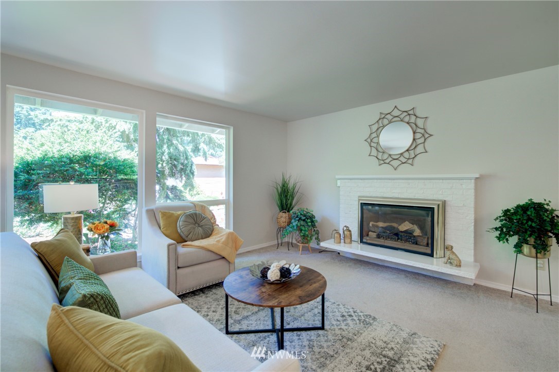 21930 3rd Place West Bothell, WA 98021 - Photo 3 of 34 a living room with furniture a window and a fireplace