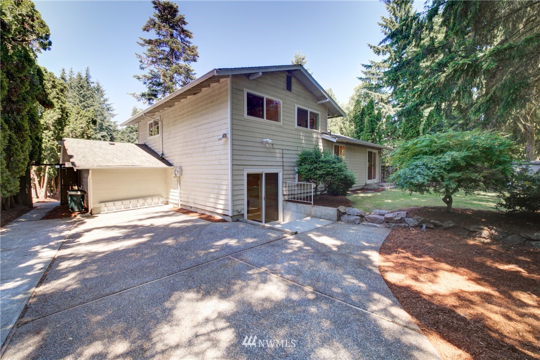 21930 3rd Place West Bothell, WA 98021 - Photo 29 of 34 a front view of a house with yard and trees
