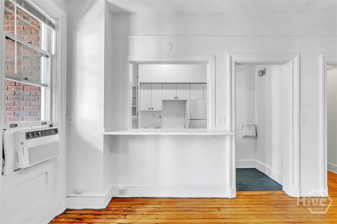 24 East Liberty, Unit 42 Savannah, GA 31401 - Photo 15 of 44 Living room is connected to kitchen with a breakfast bar passtrhough