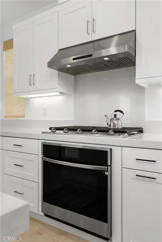 a stove top oven sitting inside of a kitchen