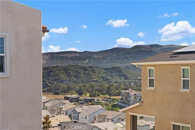 a view of a house with a mountain in the background