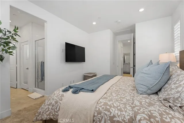 a bedroom with a bed and a flat screen tv