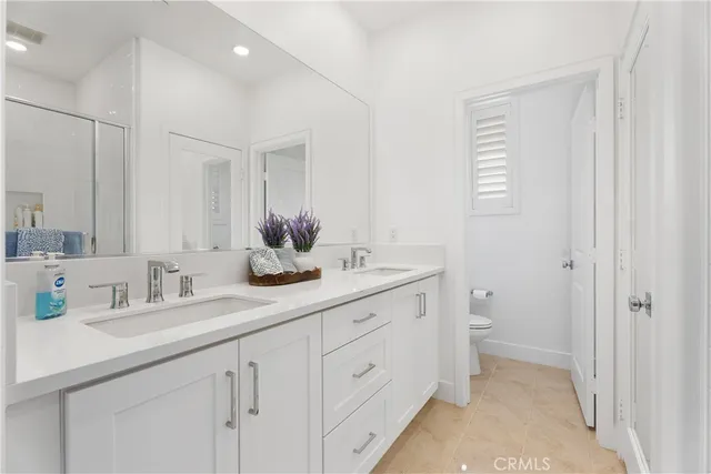 a bathroom with a double vanity sink and a mirror
