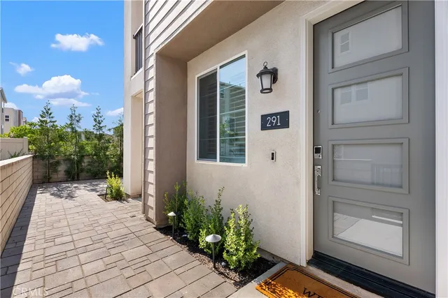 a view of a door and chair in back yard of the house