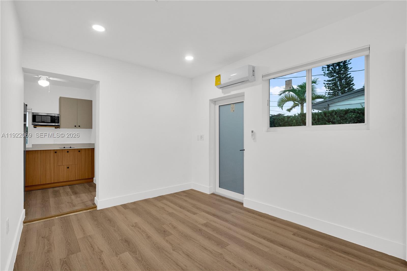 a view of a kitchen with a sink and dishwasher with wooden floor
