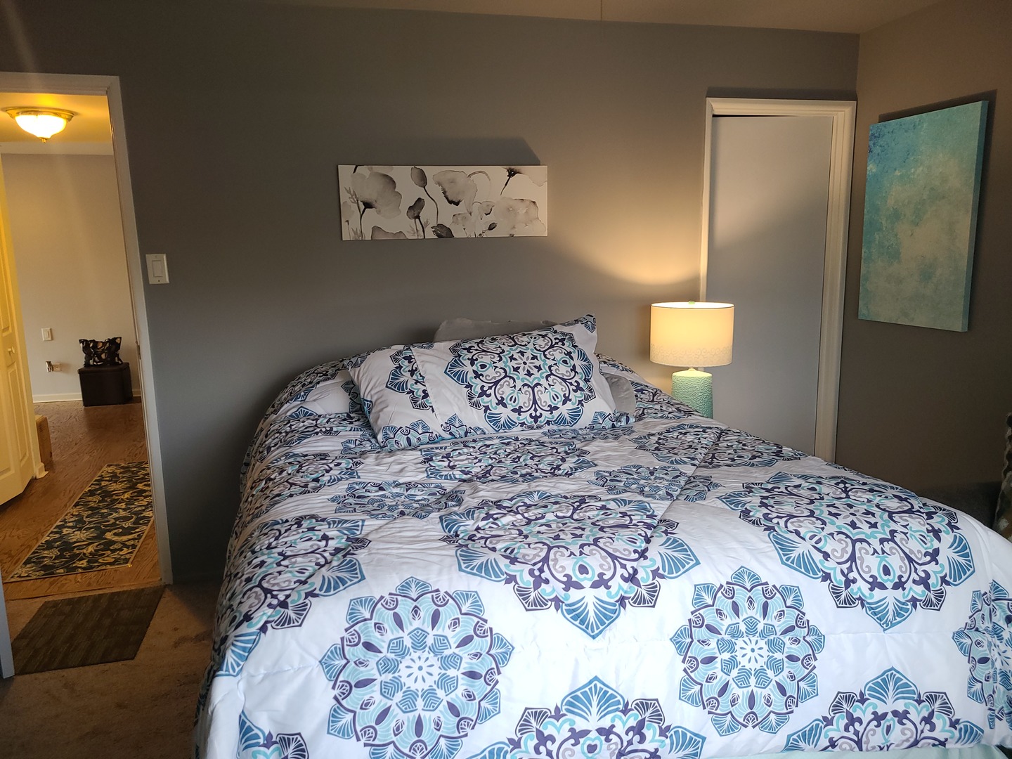 8359 West Addison Street, Unit 201 Chicago, IL 60634 - Photo 20 of 22 a bedroom with a bed and a lamp on dresser