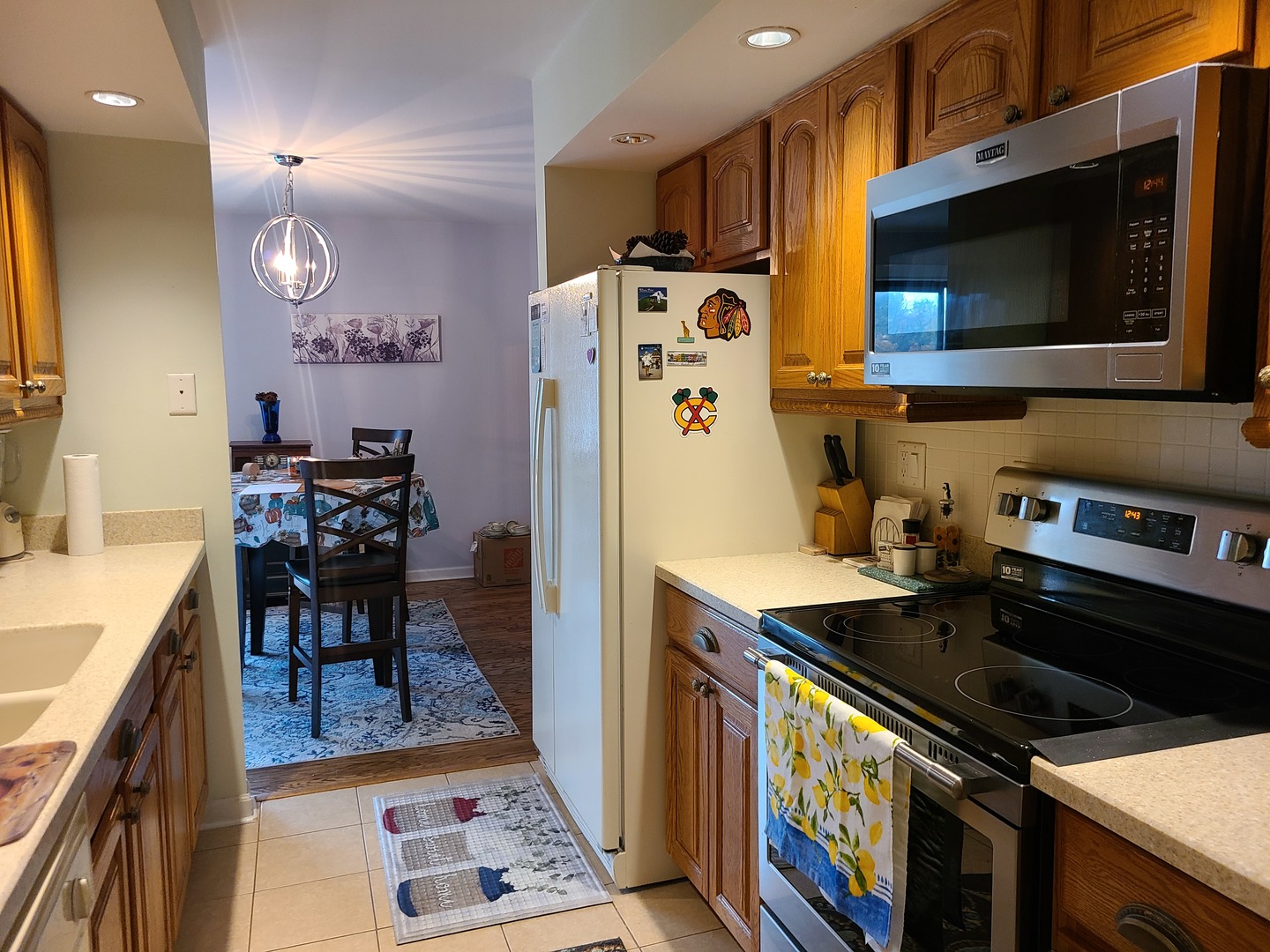 8359 West Addison Street, Unit 201 Chicago, IL 60634 - Photo 6 of 22 a kitchen with stainless steel appliances a stove a sink cabinets and a dining table