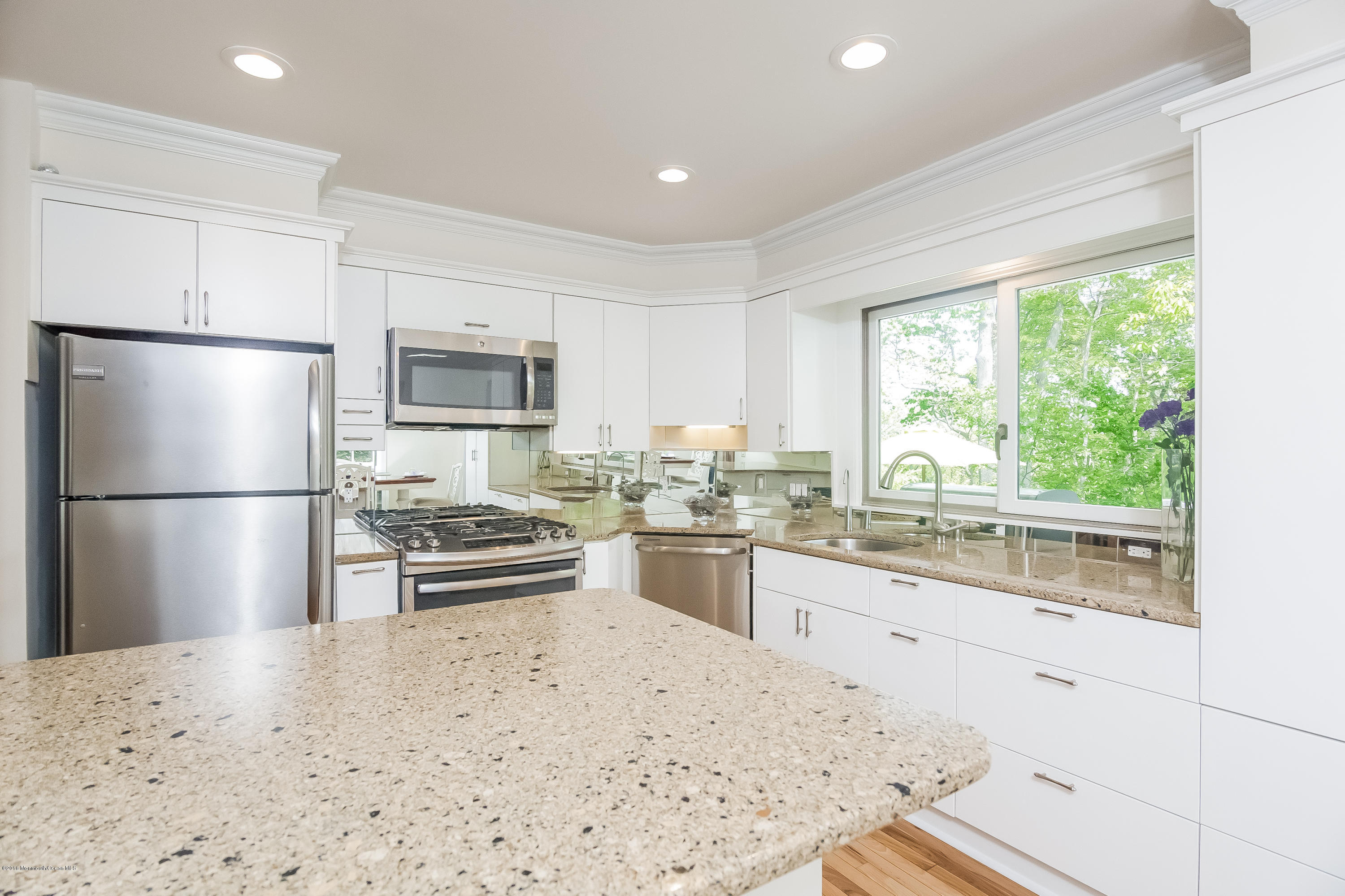 1210 Ivy Road Manasquan, NJ 08736 - Photo 14 of 25 a kitchen with granite countertop a refrigerator and a sink