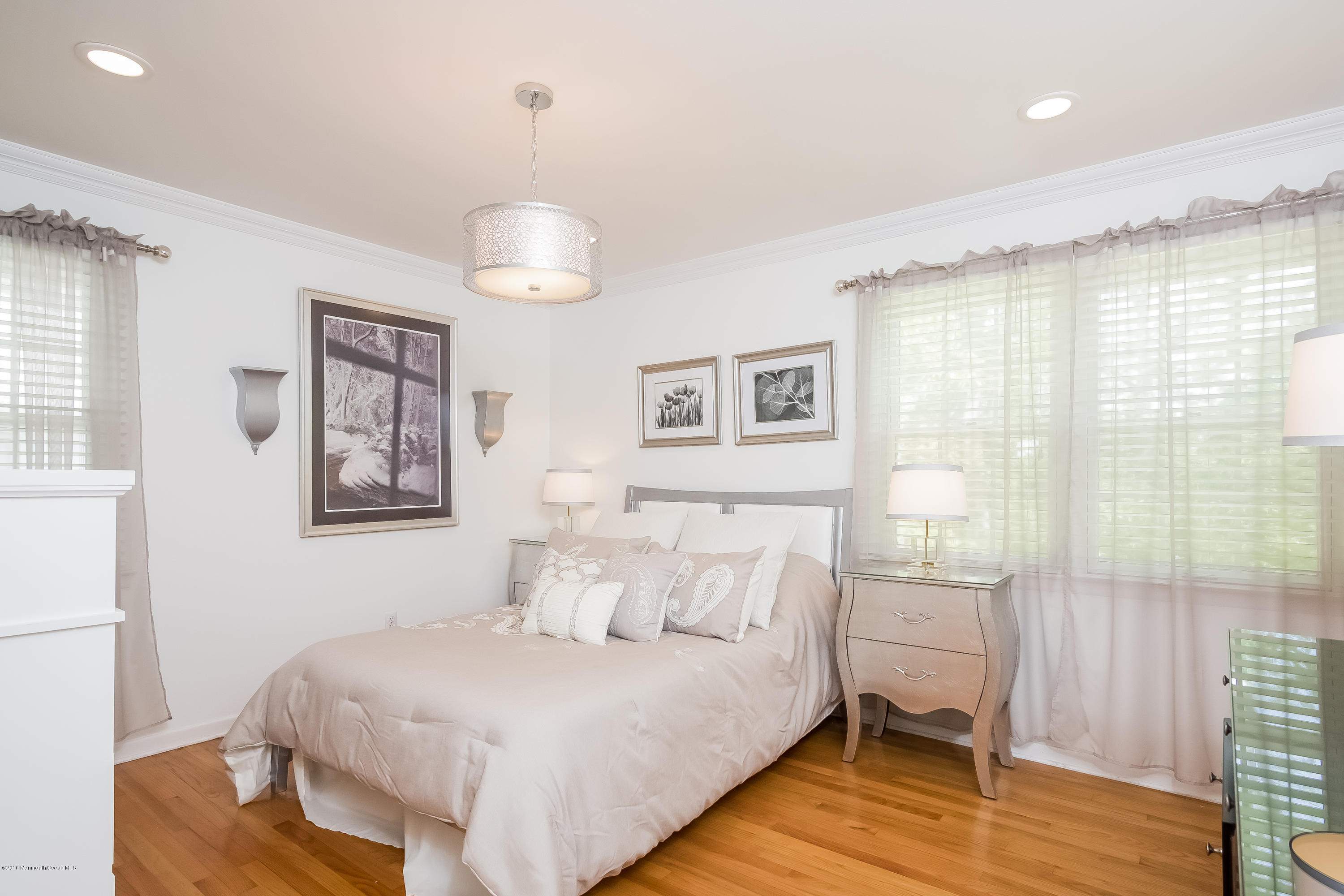 1210 Ivy Road Manasquan, NJ 08736 - Photo 17 of 25 a spacious bedroom with a bed and a window