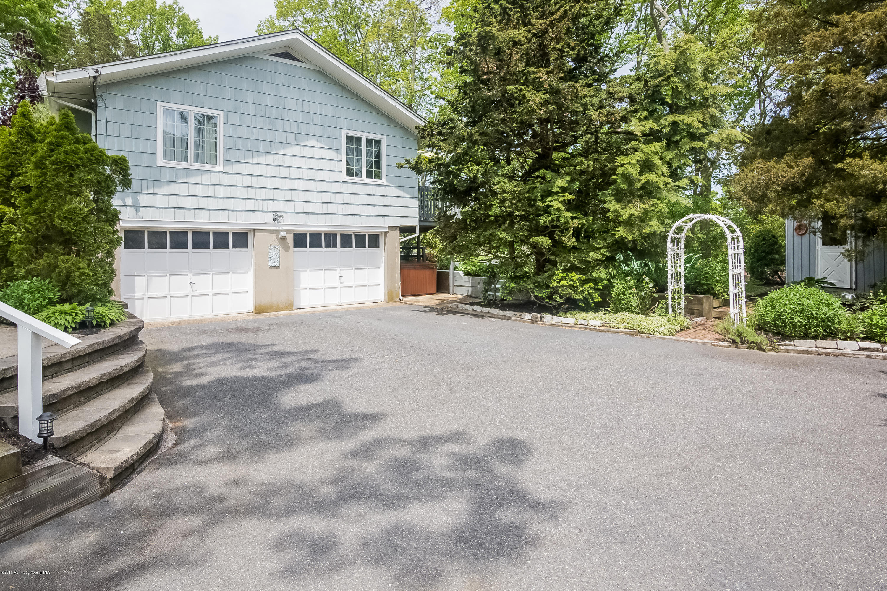 1210 Ivy Road Manasquan, NJ 08736 - Photo 5 of 25 a view of a house with a yard and garage