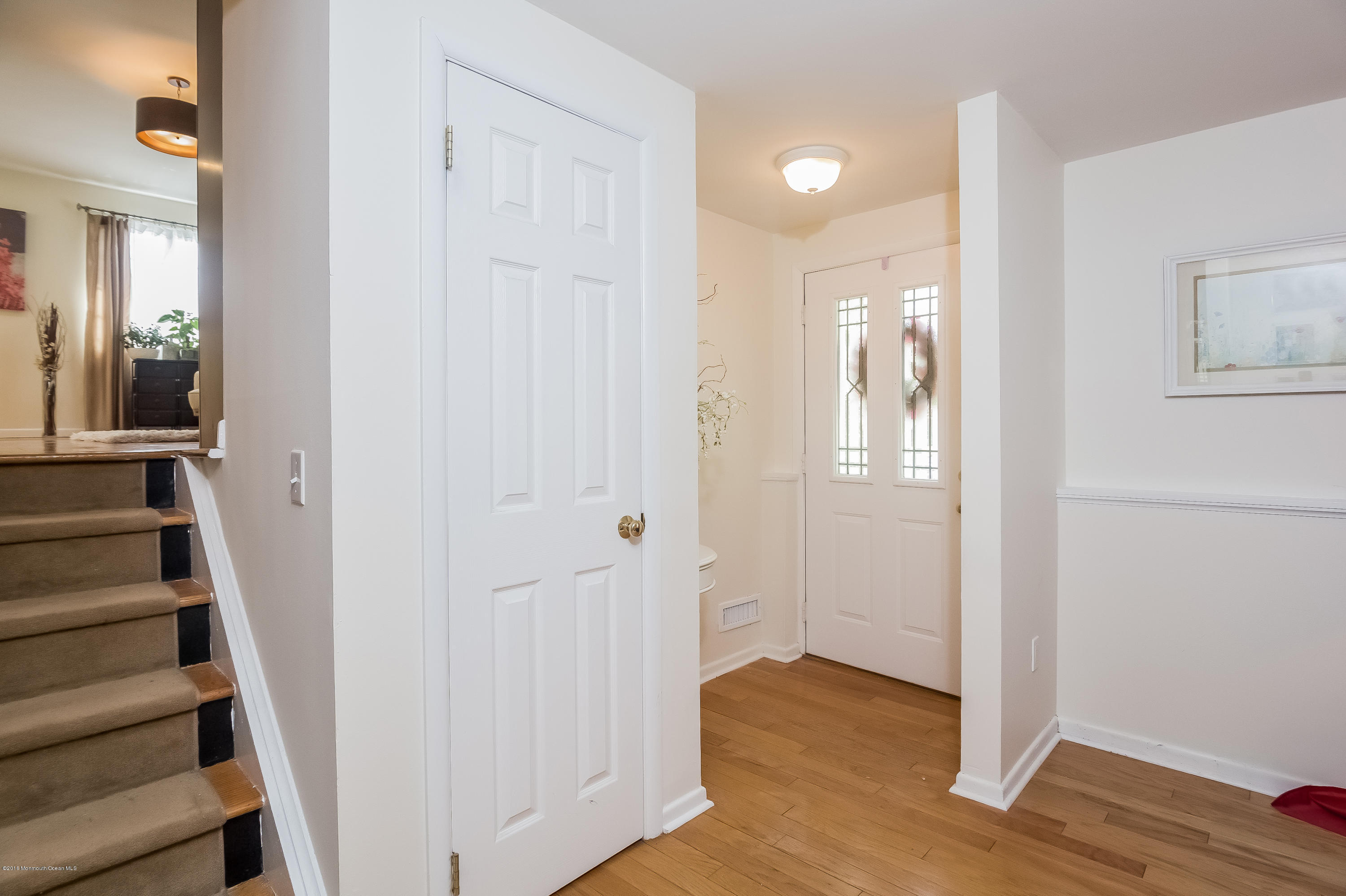 1210 Ivy Road Manasquan, NJ 08736 - Photo 8 of 25 a view of a hallway with wooden floor and entryway