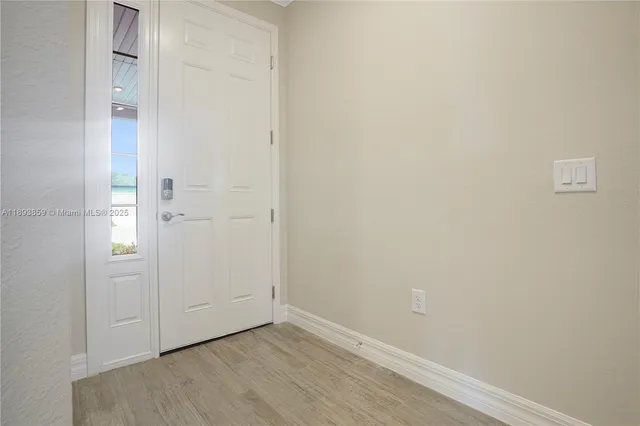 an empty room with wooden floor