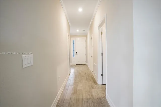a view of a hallway with wooden floor