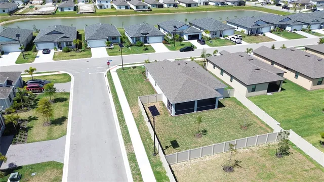 an aerial view of a house with a garden and lake view