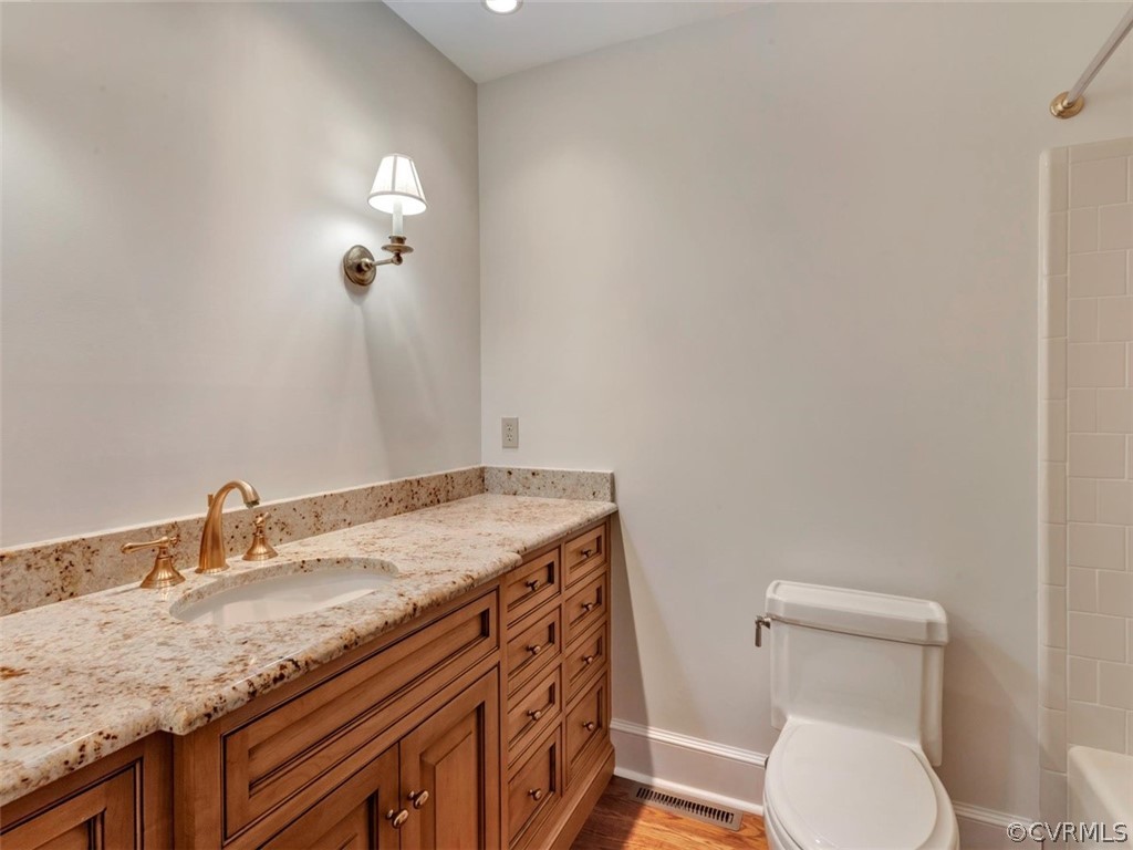 3900 Timber Ridge Road Midlothian, VA 23112 - Photo 22 of 44 a bathroom with a granite countertop sink a toilet and a mirror