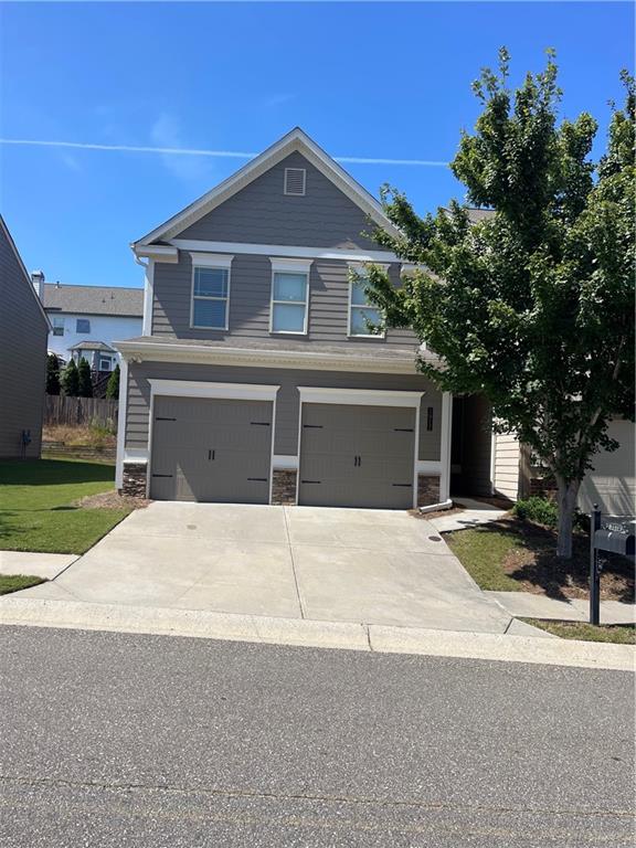 a front view of a house with a yard and garage