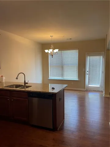 a kitchen with wooden floor and window
