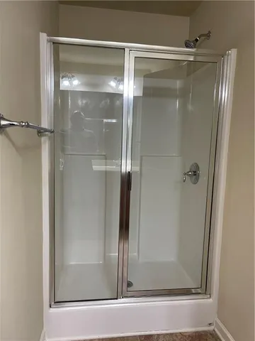 a bathroom with a glass shower door