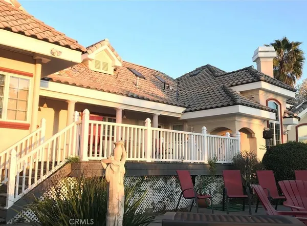 a view of a house with a wooden fence