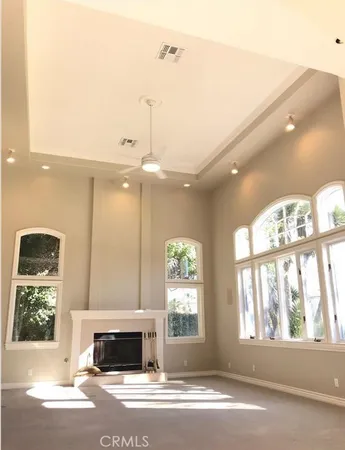 a living room with a fireplace and a large window