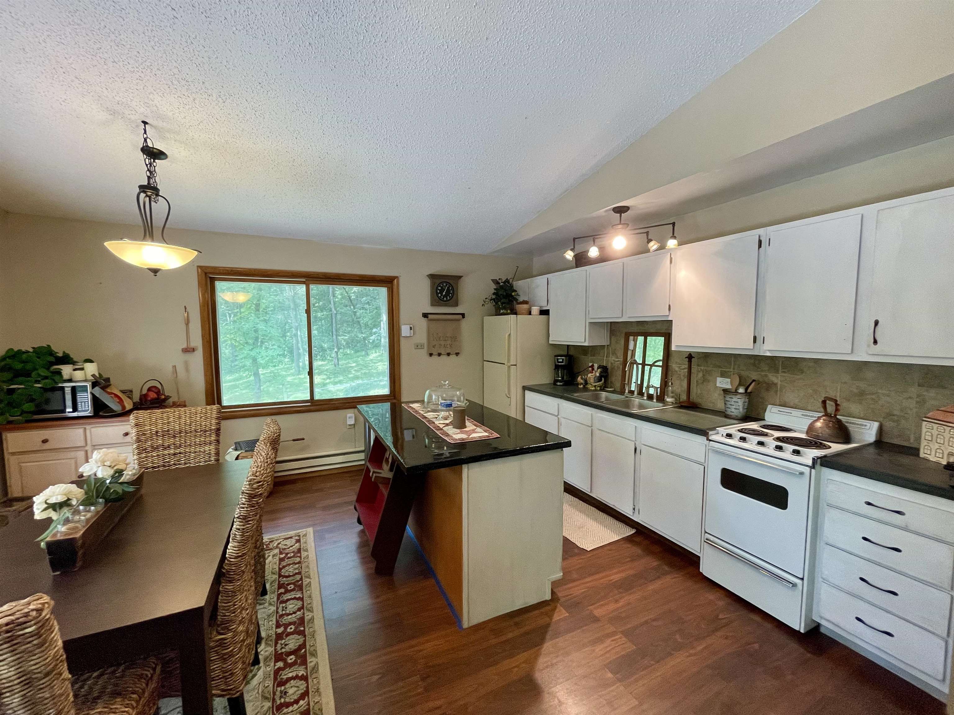8008 West Blanding Road Hanover, IL 61041 - Photo 27 of 67 a kitchen with a stove a sink and a refrigerator