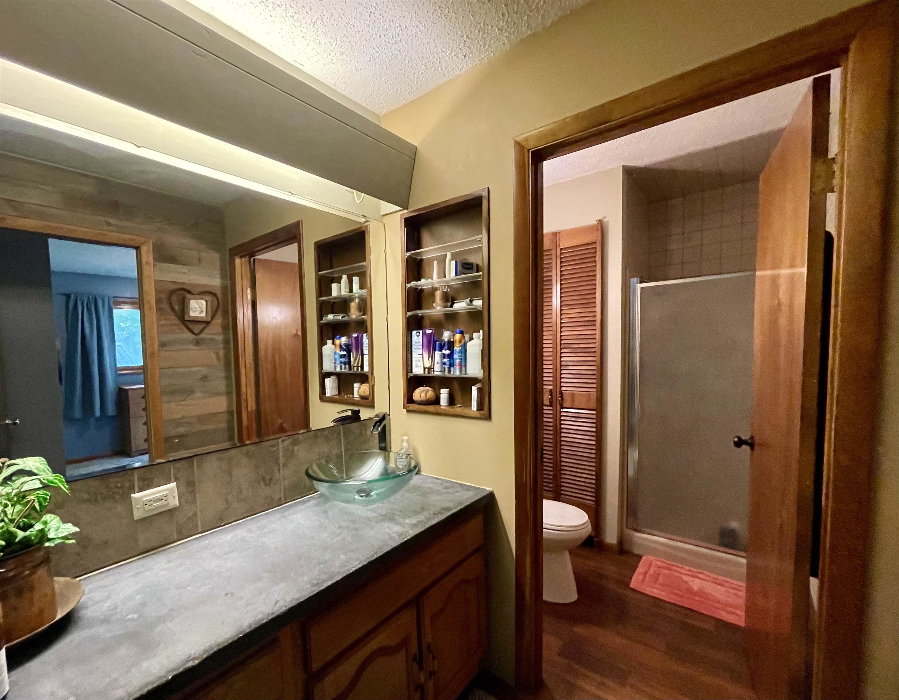 8008 West Blanding Road Hanover, IL 61041 - Photo 34 of 67 a bathroom with a granite countertop sink a toilet and shower