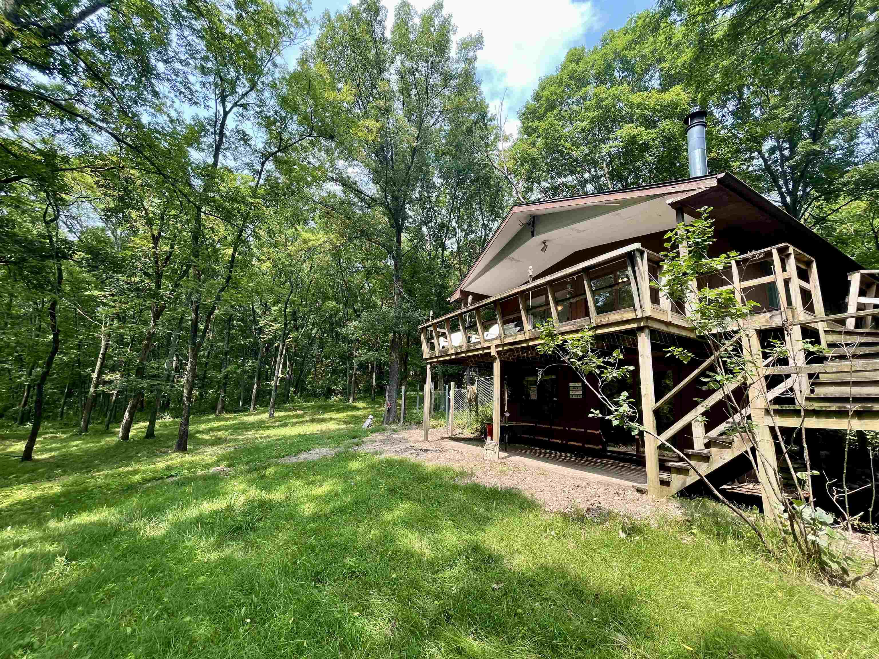 8008 West Blanding Road Hanover, IL 61041 - Photo 9 of 67 a view of a wooden deck with a big yard and large trees