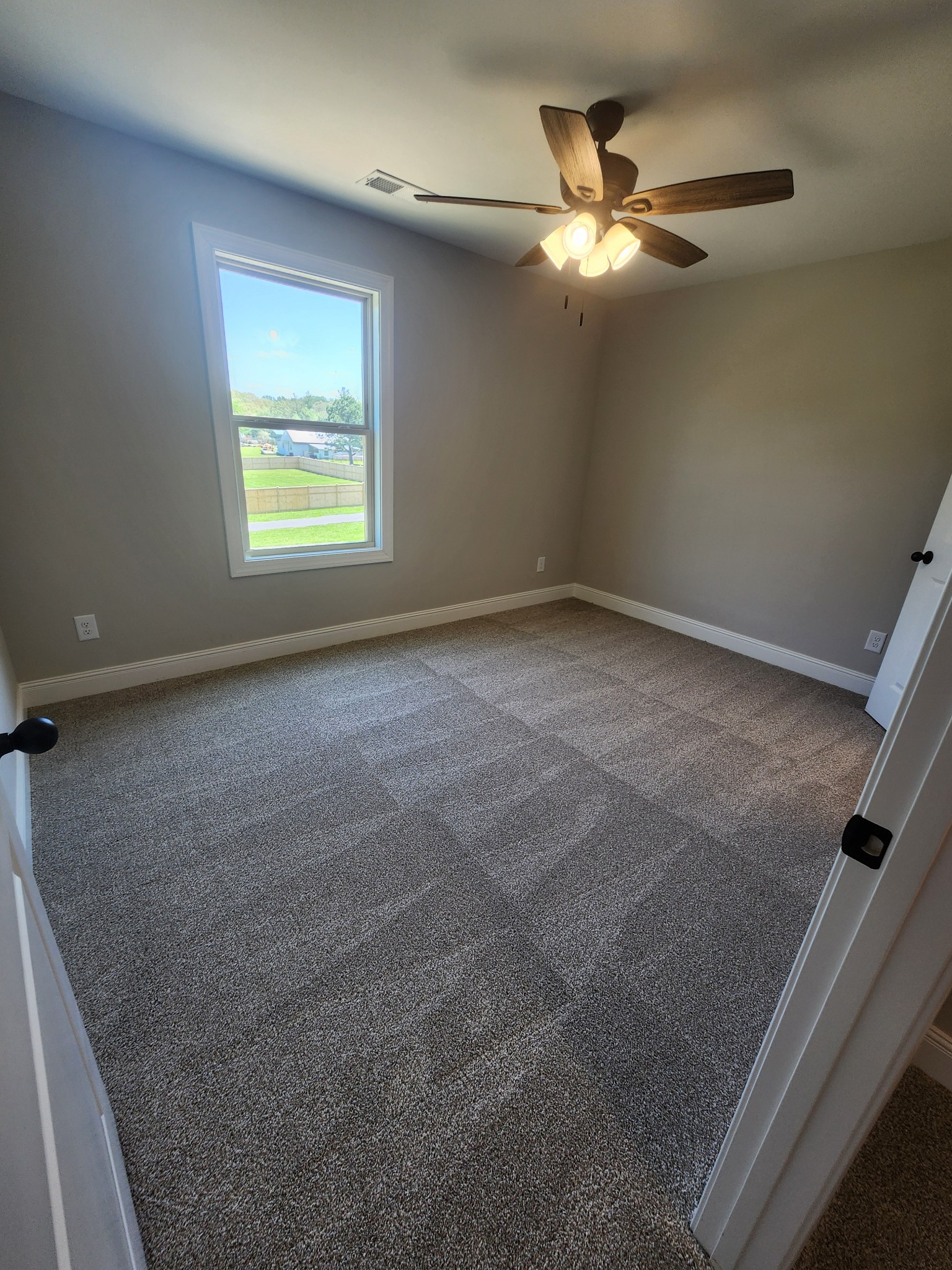 8963 Covington Road White House, TN 37188 - Photo 29 of 32 an empty room with a ceiling fan and window
