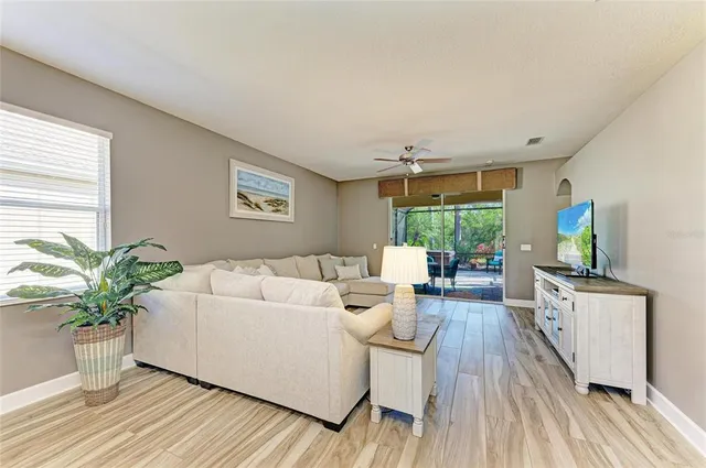 a bedroom with a bed and a flat tv screen on dresser