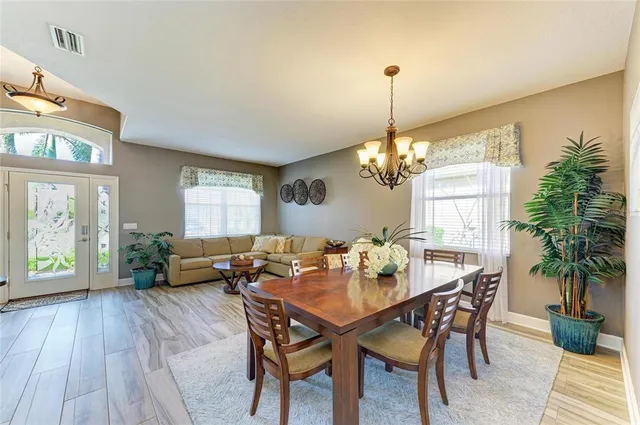 a bedroom with a large bed and a chandelier