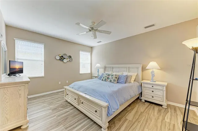 a bedroom with a large bed and a chandelier
