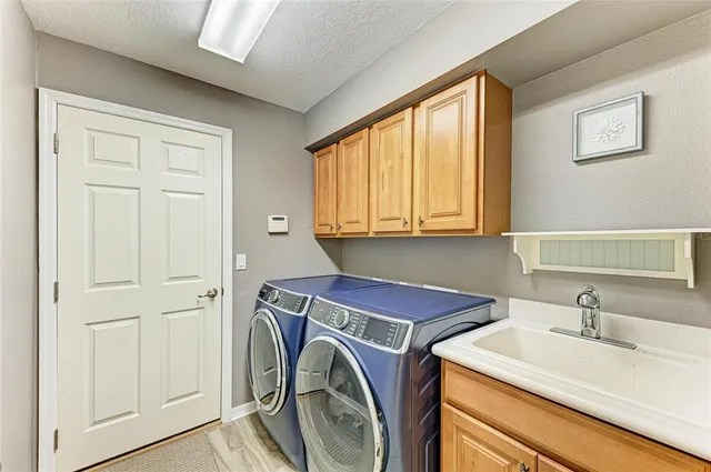 an aerial view of ocean and residential houses with outdoor space