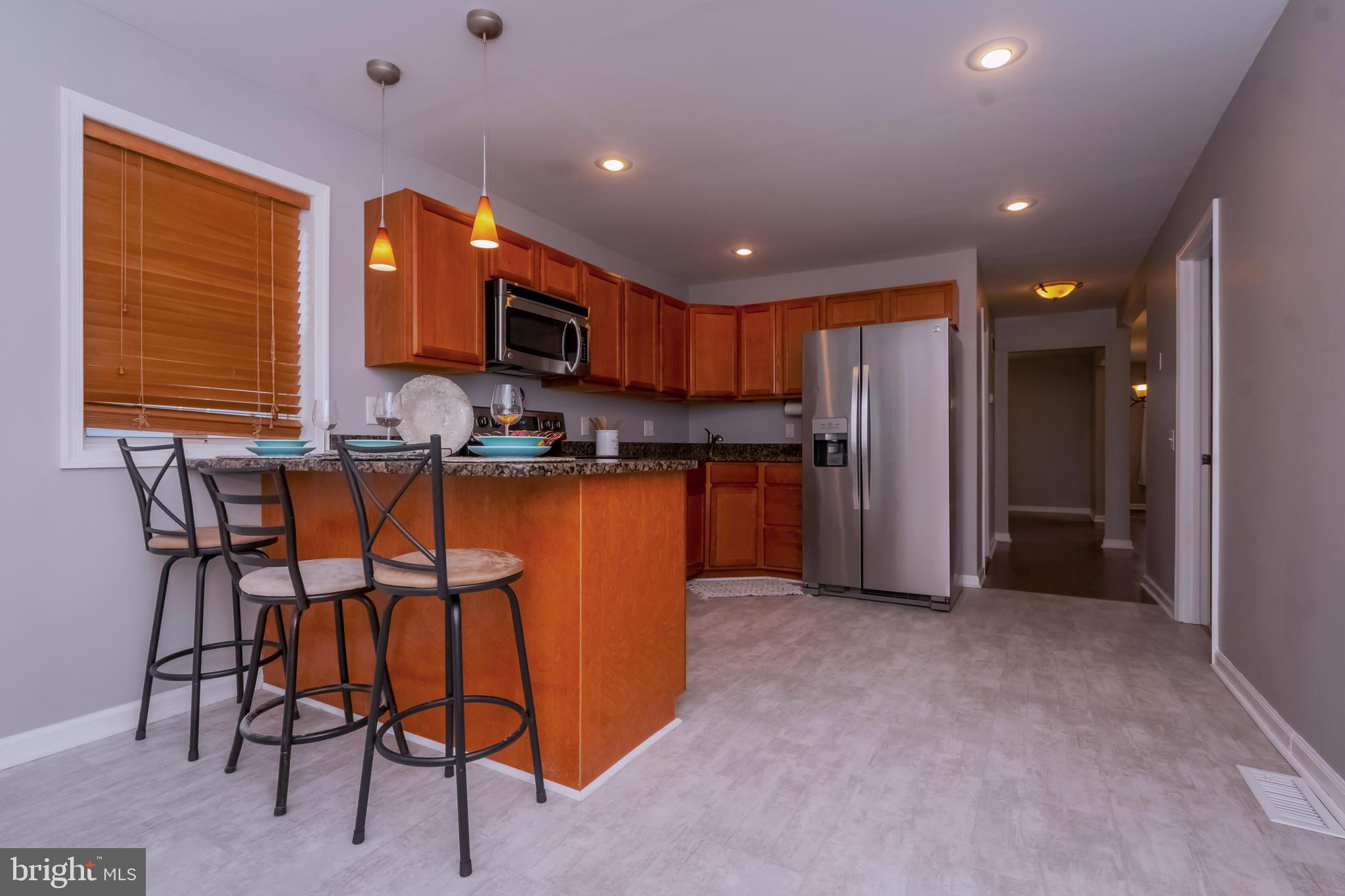 3945 North Point Road Dundalk, MD 21222 - Photo 10 of 31 Kitchen with Breakfast Bar & Granite Counters