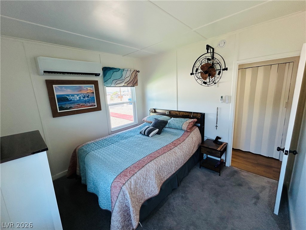 116 West Basic Road Henderson, NV 89015 - Photo 23 of 39 A well-lit bedroom features plush carpeting and a convenient split-unit air conditioner.