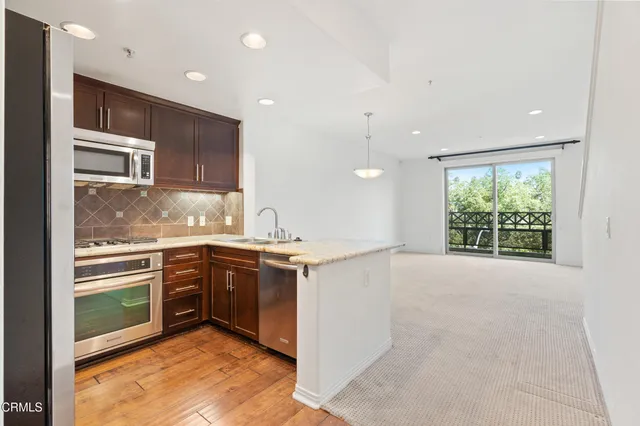 a kitchen with stainless steel appliances granite countertop a stove and a sink