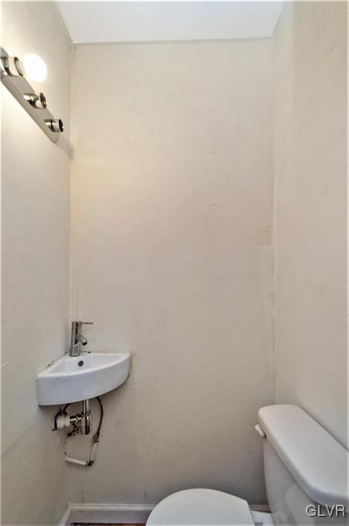 917 High Street Bethlehem, PA 18018 - Photo 9 of 25 a bathroom with a toilet a sink and mirror