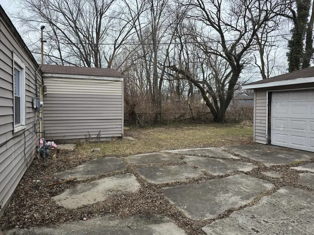a front view of house with a garden