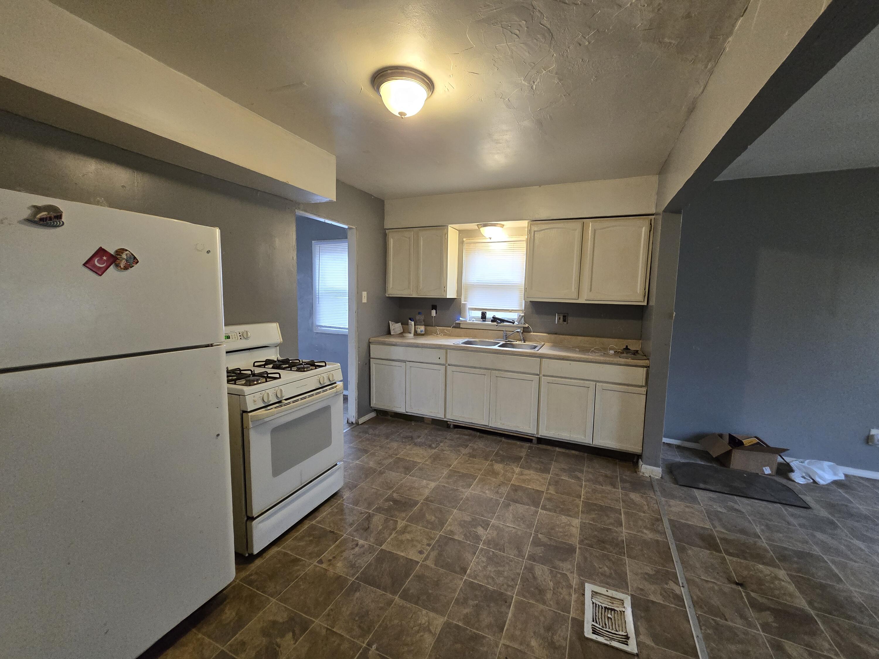 1119 Cass Street Gary, IN 46403 - Photo 6 of 20 a kitchen with granite countertop a sink appliances cabinets and counter space